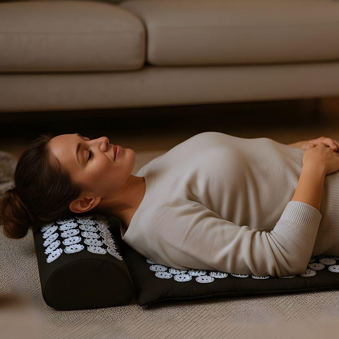 Woman lying on an acupressure mat in a living room setting